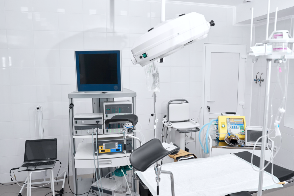 Clinical procedure room with medical equipment and patient table