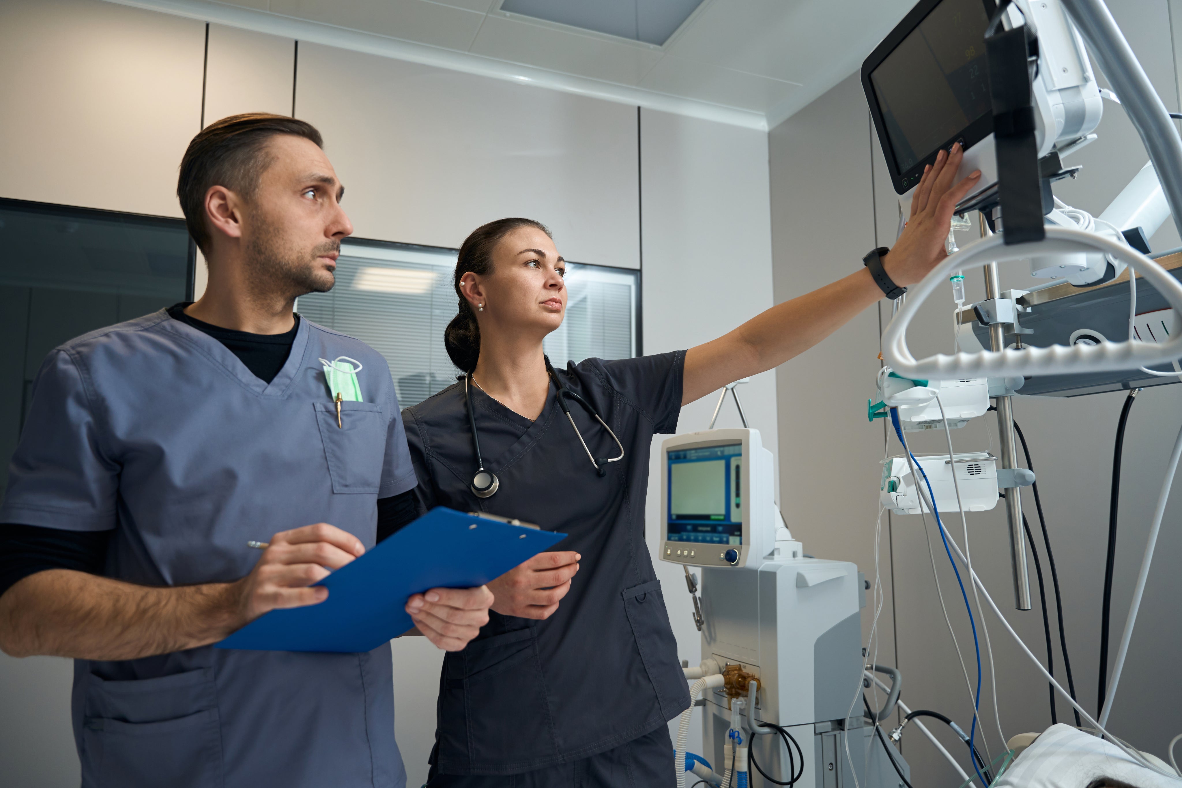 Healthcare professionals reviewing equipment in a clinical setting
